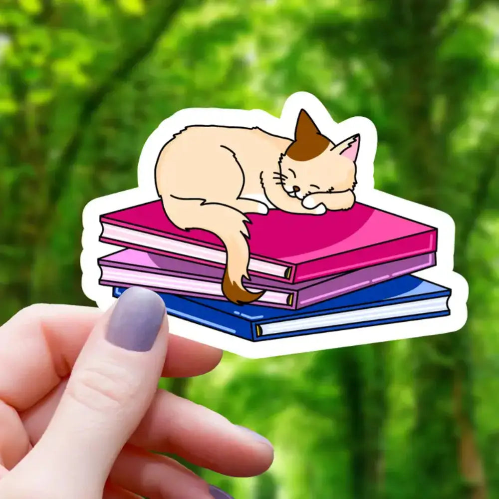 Cat Sleeping on Pride Books Sticker - Brown Cat Bisexual Books - Gifts