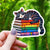 Cat Sleeping on Pride Books Sticker - Grey Tabby Rainbow Books - Gifts