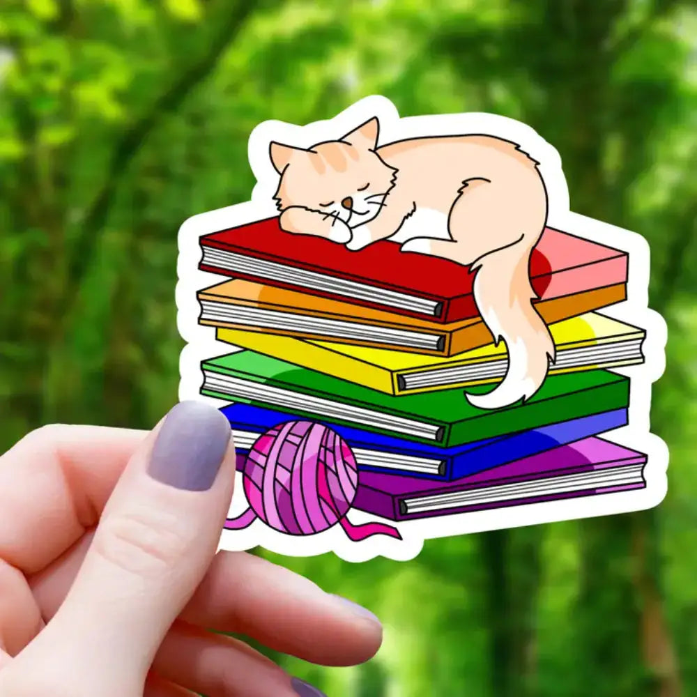Cat Sleeping on Pride Books Sticker - Orange Cat Rainbow Books - Gifts
