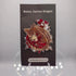 A detailed enamel pin of a whimsical bone-themed carrion dragon in red and beige on a branded backing card