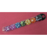 Set of colorful polyhedral dice in a clear tube on a red background