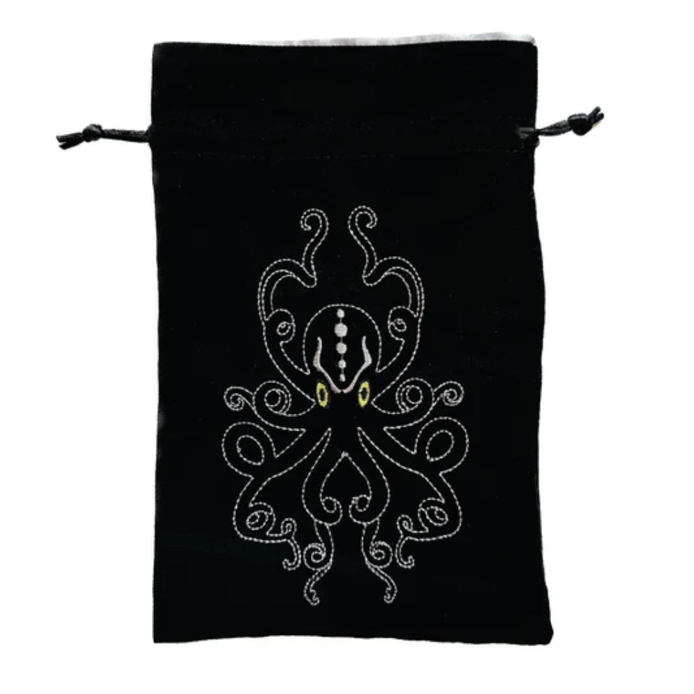 Black velvet kraken dice bag with embroidered white octopus and yellow eyes featuring drawstring closure