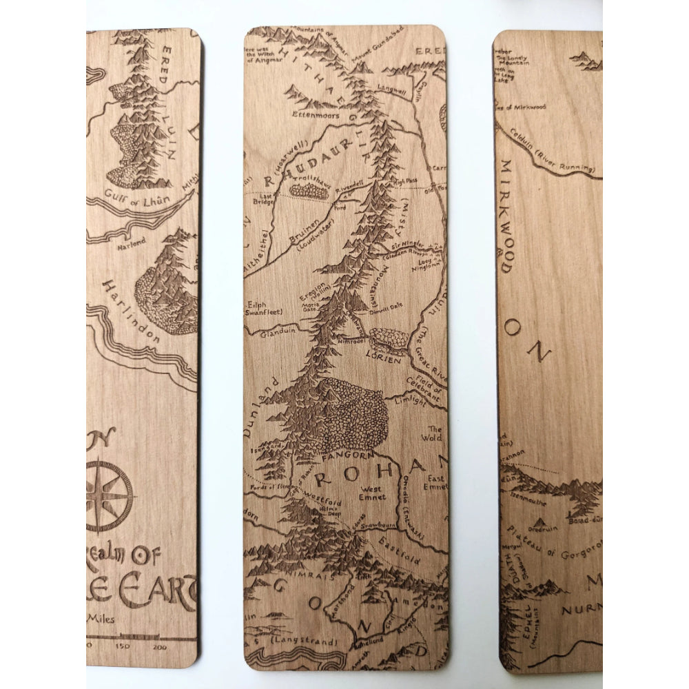 Three wooden middle earth bookmarks engraved with detailed lord of the rings maps in natural wood color