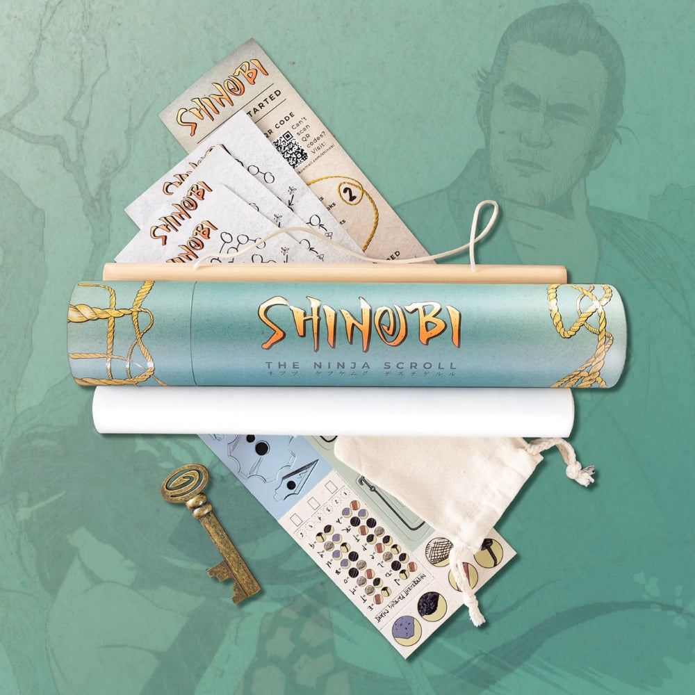 A light blue cylindrical scroll tube with gold rope and orange shinobi lettering from shinobi the ninja scroll puzzle game