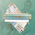 A light blue cylindrical scroll tube with gold rope and orange shinobi lettering from shinobi the ninja scroll puzzle game