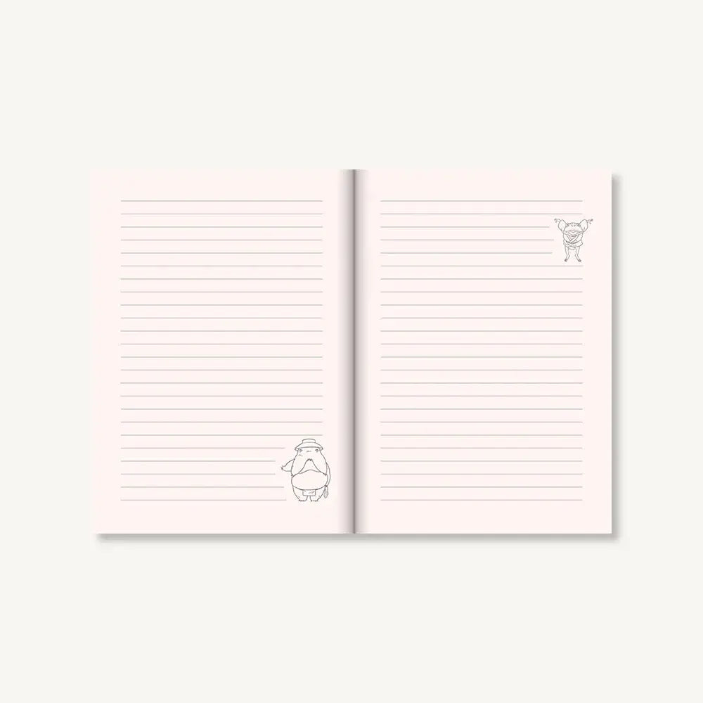 A soft pink ruled Studio Ghibli journal with delicate black line drawings of cartoon characters on the pages