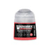 A small cylindrical bottle of Warhammer Tone Pro Bloodtoof Red paint with clear plastic cap and vibrant red label