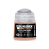 A small translucent plastic bottle of Warhammer Tone Pro Celestine Skin paint with beige contents and black label