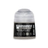 A small cylindrical bottle of Warhammer Tone Pro paint in dataslate grey color for miniature painting
