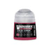 A small translucent plastic bottle of Warhammer Tone Pro Eye of Terror pink paint in 12ml size