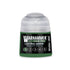 A small cylindrical bottle of Warhammer Tone Pro paint in lustria green with a clear plastic cap and black label
