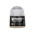 A small cylindrical bottle of Warhammer Tone Pro Necrolith Bone 12ml acrylic paint with a clear cap and black label