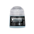 A small translucent plastic bottle of warhammer tone pro stormwolf blue paint with a black label and light blue liquid inside