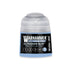 A small translucent plastic bottle of Warhammer Tone Pro Ultramar Blue miniature paint with a clear cap and black label