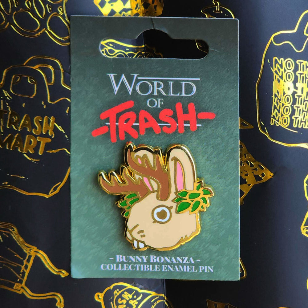 Beige hard enamel pin from world of trash featuring a bunny with antlers and green leaves called bunny bonanza